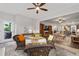 Open concept sunroom with wicker furniture leading to the kitchen and living room at 7430 Ramsgate Ct, Cumming, GA 30040