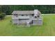 A spacious backyard features a large deck with a grill, and additional stairs down to a fenced-in area at 125 Pebble Beach Ct, Atlanta, GA 30349