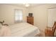Cozy bedroom featuring carpet, twin bed, closet storage, and a window with natural light at 125 Pebble Beach Ct, Atlanta, GA 30349