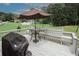 Outdoor deck area with a table, benches, and grill, perfect for outdoor dining at 125 Pebble Beach Ct, Atlanta, GA 30349