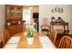 Dining room with a wood table set and hutch, featuring seating for six and a view into the living room at 125 Pebble Beach Ct, Atlanta, GA 30349