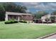 Charming two-story brick home featuring a two-car garage and covered parking area, beautifully landscaped front yard at 125 Pebble Beach Ct, Atlanta, GA 30349