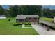 Aerial view of a two-story brick home with a two-car garage, covered parking, and a well-manicured lawn at 125 Pebble Beach Ct, Atlanta, GA 30349