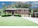Charming two-story brick home featuring a two-car garage and covered parking area, beautifully landscaped front yard at 125 Pebble Beach Ct, Atlanta, GA 30349
