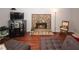 Cozy living room features a stone fireplace and hardwood floors, perfect for relaxation at 125 Pebble Beach Ct, Atlanta, GA 30349