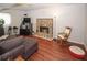 Living room with hardwood floors, stone fireplace, and a cozy rocking chair at 125 Pebble Beach Ct, Atlanta, GA 30349