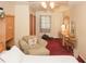 Bedroom with an upholstered chair, vanity, storage, and carpet at 125 Pebble Beach Ct, Atlanta, GA 30349