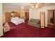 Spacious bedroom with a king bed, sitting area, red carpet, and closet storage at 125 Pebble Beach Ct, Atlanta, GA 30349
