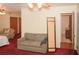 Bedroom featuring a sitting area with a sofa, plush red carpet, and view of the ensuite bathroom at 125 Pebble Beach Ct, Atlanta, GA 30349