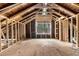 Unfinished attic with exposed wooden beams, framing, and a window showcasing natural light at 1406 Allene Sw Ave, Atlanta, GA 30310