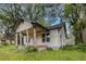 Exterior view of a home under renovation, featuring a covered porch and lush greenery at 1406 Allene Sw Ave, Atlanta, GA 30310