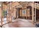 Unfinished interior ready for renovation showcasing exposed framing with natural light from new windows at 1406 Allene Sw Ave, Atlanta, GA 30310