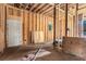 Under-construction interior shows new wood framing and a door, offering a canvas for creating a modern layout with custom features at 1406 Allene Sw Ave, Atlanta, GA 30310