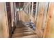 Unfinished wooden staircase leading to the upper level, framed with natural wood and plywood accents at 1406 Allene Sw Ave, Atlanta, GA 30310