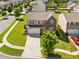 Aerial shot of home, showcasing the lush lawn, brick facade, and inviting curb appeal at 1560 Avalon Creek Rd, Sugar Hill, GA 30518