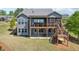 Spacious backyard featuring a multi-level deck with a screened porch, perfect for outdoor entertaining at 413 Horizon Trl, Canton, GA 30114