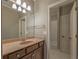 Bathroom featuring a vanity with a large mirror, a sink and a view to the shower at 6186 Talmadge Nw Run, Acworth, GA 30101
