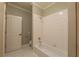 Bathroom features white tile and shower-tub combo at 6186 Talmadge Nw Run, Acworth, GA 30101