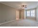 Spacious bedroom featuring a ceiling fan, neutral paint, and natural light from the double windows at 6186 Talmadge Nw Run, Acworth, GA 30101