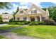 Charming home featuring a well-manicured lawn and lovely, trimmed greenery and sidewalk to the front door at 6186 Talmadge Nw Run, Acworth, GA 30101
