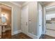 Hallway features doors to the bathroom and laundry room with white cabinets at 6186 Talmadge Nw Run, Acworth, GA 30101
