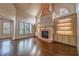 Bright living room with a tall fireplace and hardwood floors at 6186 Talmadge Nw Run, Acworth, GA 30101