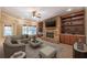Cozy living room featuring a stone fireplace, built-in shelving and a comfortable seating area at 6186 Talmadge Nw Run, Acworth, GA 30101