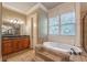 Main bathroom with soaking tub, tiled shower, and granite counters at 6186 Talmadge Nw Run, Acworth, GA 30101
