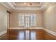 Spacious main bedroom featuring hardwood floors, tray ceiling and access to the balcony at 6186 Talmadge Nw Run, Acworth, GA 30101