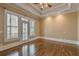 Spacious main bedroom featuring hardwood floors, tray ceiling and access to the balcony at 6186 Talmadge Nw Run, Acworth, GA 30101