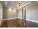 Spacious main bedroom features a trey ceiling, ceiling fan and gleaming hardwood floors at 6186 Talmadge Nw Run, Acworth, GA 30101
