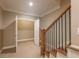Staircase with carpeted steps, wood trim and railing with iron balusters at 6186 Talmadge Nw Run, Acworth, GA 30101