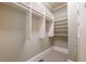 Walk-in closet features carpet flooring, with shelving and hanging rods for clothes at 6186 Talmadge Nw Run, Acworth, GA 30101