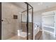 Bathroom shower featuring marble tile, glass shower door, and view into the Primary bedroom at 1500 Alcovy Station Rd, Covington, GA 30014