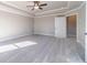Large bedroom with neutral walls, carpet flooring, ceiling fan, and a door at 1500 Alcovy Station Rd, Covington, GA 30014