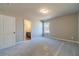 Neutral bedroom boasts plush carpeting, natural light and an ensuite bathroom with dark vanity at 1500 Alcovy Station Rd, Covington, GA 30014