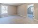 Bedroom with plush carpet, natural light from the window, and neutral colored walls at 1500 Alcovy Station Rd, Covington, GA 30014