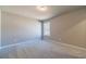 Bright bedroom features plush carpet flooring, neutral walls and natural light from the window at 1500 Alcovy Station Rd, Covington, GA 30014