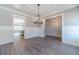 Elegant dining room featuring wood-look floors, decorative wainscoting, stylish lighting, and open floor plan at 1500 Alcovy Station Rd, Covington, GA 30014