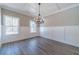 Bright dining room showcasing wood-look floors, wainscotting, and ample natural light from large windows at 1500 Alcovy Station Rd, Covington, GA 30014