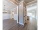 Dining room with wood-look flooring, wainscotting, modern lighting and open access to other rooms at 1500 Alcovy Station Rd, Covington, GA 30014