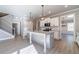 Modern kitchen with a large island, stainless steel appliances, and open layout to the living area and staircase at 1500 Alcovy Station Rd, Covington, GA 30014