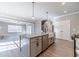 Open kitchen featuring an island with granite countertops, farmhouse sink, and stainless steel appliances at 1500 Alcovy Station Rd, Covington, GA 30014