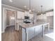 Kitchen featuring island with breakfast bar, shaker cabinets, modern appliances and adjacent entry and dining area at 1500 Alcovy Station Rd, Covington, GA 30014