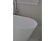 Modern white soaking tub with chrome fixtures and a minimalist design, creating a spa-like atmosphere at 1670 Knob Creek Nw Ct, Acworth, GA 30101