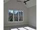 Sunlit bedroom showcasing a ceiling fan and large windows offering views of the property at 1670 Knob Creek Nw Ct, Acworth, GA 30101