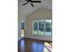 Bedroom with hardwood floors featuring a ceiling fan and large windows overlooking a scenic waterfront at 1670 Knob Creek Nw Ct, Acworth, GA 30101