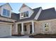 Beautiful brick home featuring a side-entry garage, covered porch, and classic design at 1670 Knob Creek Nw Ct, Acworth, GA 30101