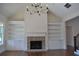 Beautiful brick fireplace with white built-ins, vaulted ceiling, and hardwood floors at 1670 Knob Creek Nw Ct, Acworth, GA 30101