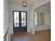 Inviting foyer with hardwood floors, decorative trim, and glass-paneled double doors at 1670 Knob Creek Nw Ct, Acworth, GA 30101